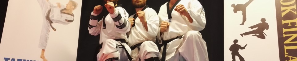 Fresh black belts and the examiner after the belt exam